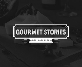 Gourmet stories logotipas. Sūriai, vytintos mėsos gaminiai, jūros gerybės, kiti skanėstai pagrinde iš Italijos, Ispanijos, Prancūzijos.