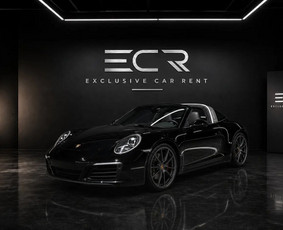 A black 2024 911 Targa 4S with a 3.0-litre twin-turbo flat-six (310 kW, about 420 hp), PDK gearbox and all-wheel drive. The glass roof folds away at the touch of a button, so you get a convertible an...
