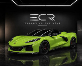 A 2023 Chevrolet Corvette C8 convertible in bright green with a red leather interior. The 6.2-litre V8 sits behind the seats (369 kW, about 500 hp), and the hard roof folds away at the touch of a but...