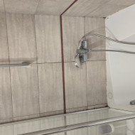 Vonioje sutvarkyt silikoną ir glaistą tarp plytelių